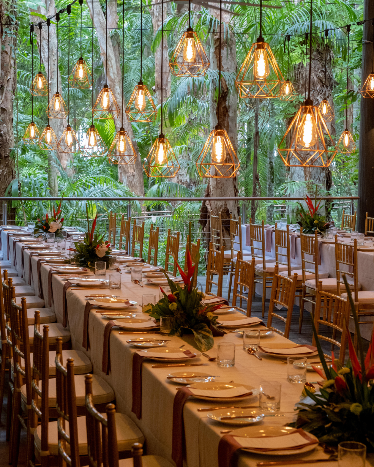 Melaleuca Resort - Palm cove weddings - Dining setting with pendant lights and flower center pieces