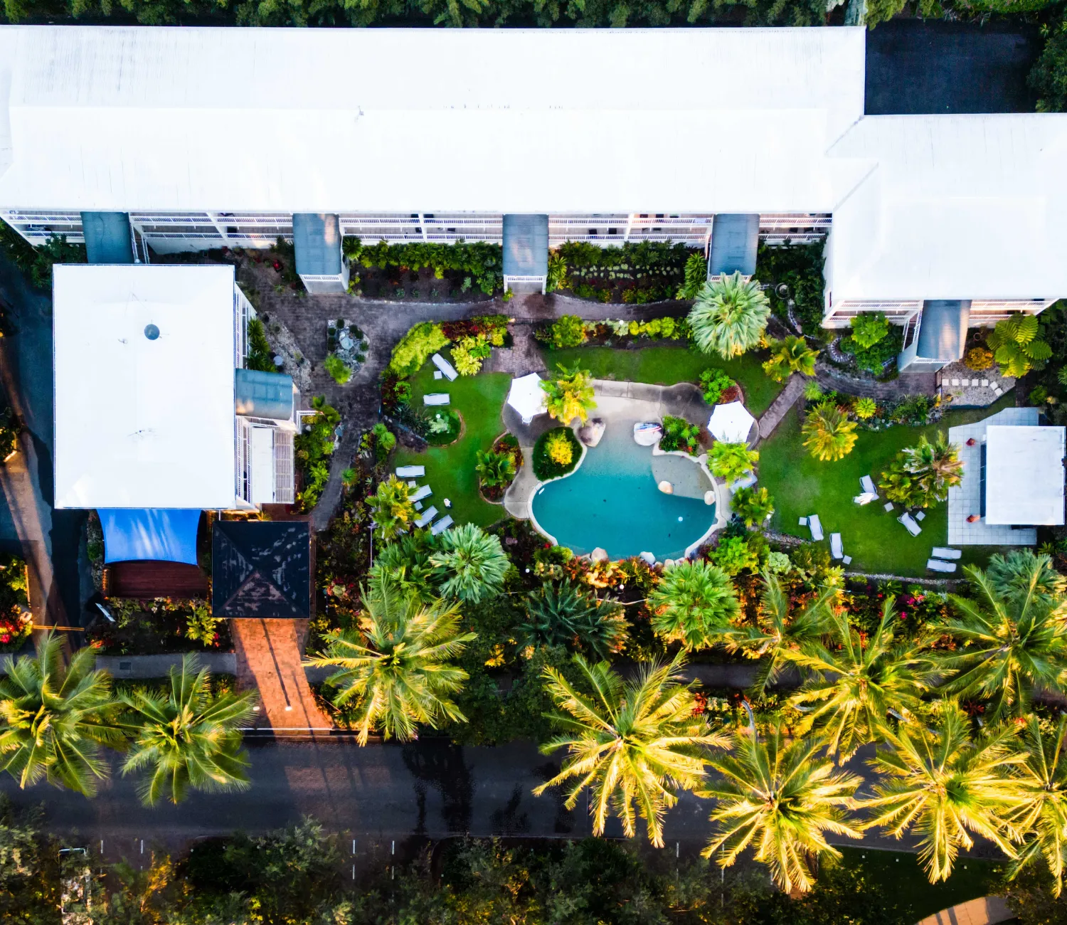 birds eye view of Melaleuca Resort Showing the pool and outdoor area with lush gardens and beautiful palm trees.