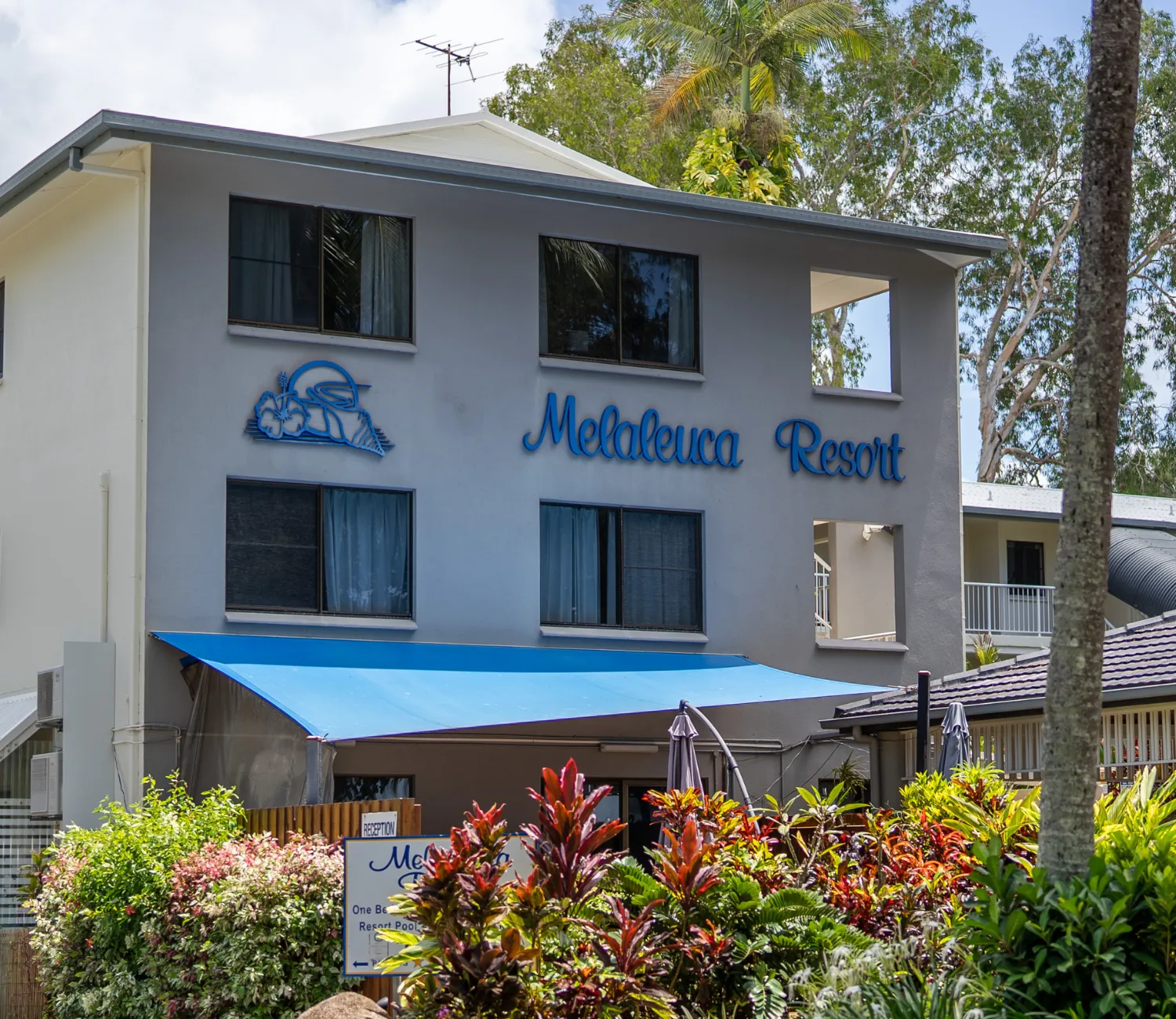 front of the Melaleuca Resort apartment block with signage and gardens